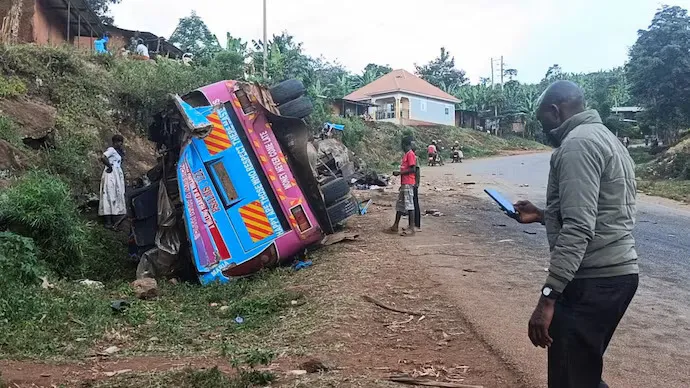 people-stand-near-the-wreckage-of-a-bus--owned-by-king-david-junior-school-171853883-16x9_0